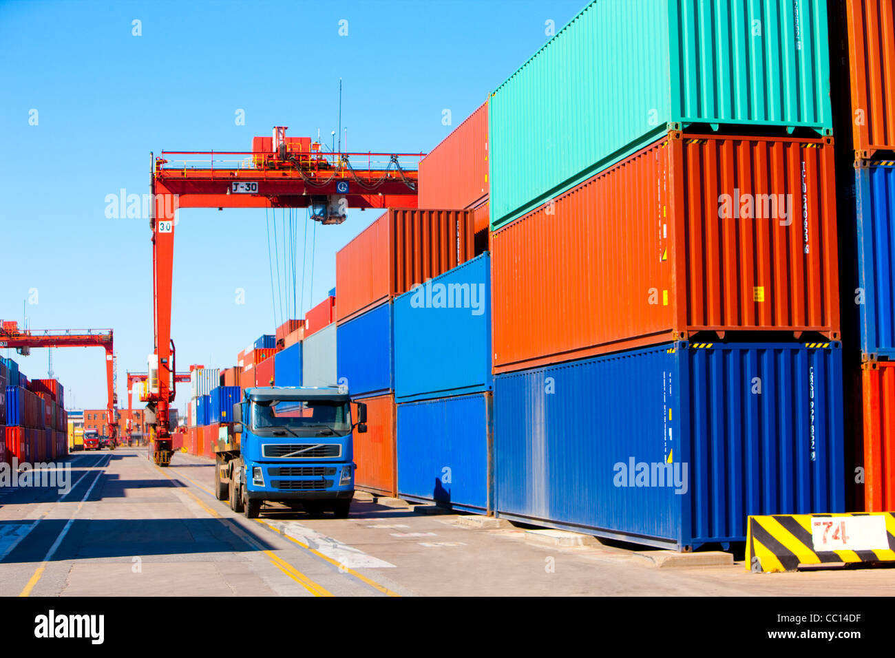 Cranes, trucks and cargo containers in shipping dock Stock Photo Alamy