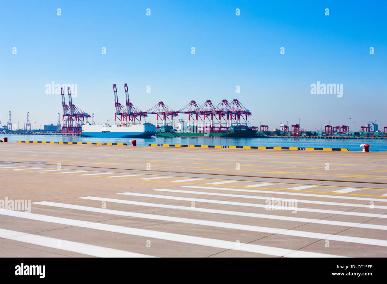 Cranes and cargo ships on the shipping dock Stock Photo