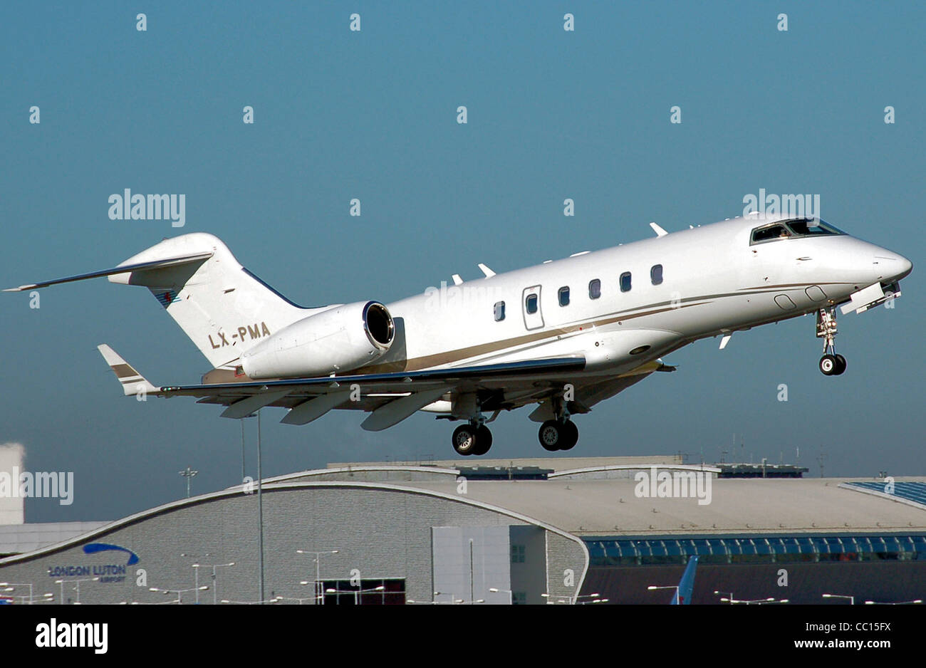 Bombardier Challenger 300 (with Luxembourg registration LX-PMA) takes off from London Luton Airport, Stock Photo