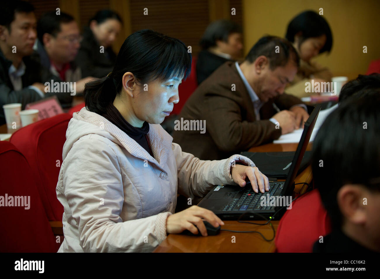 A female cadre student uses laptop while attending a lecture in Beijing Communist Party School in Beijing, China. 21-Nov-2011 Stock Photo