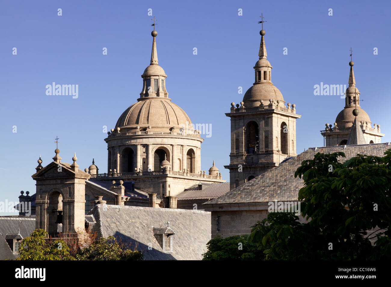 San Lorenzo de El Escorial Monastery - towers of the church and monastery are set of by a bright blue sky. Stock Photo