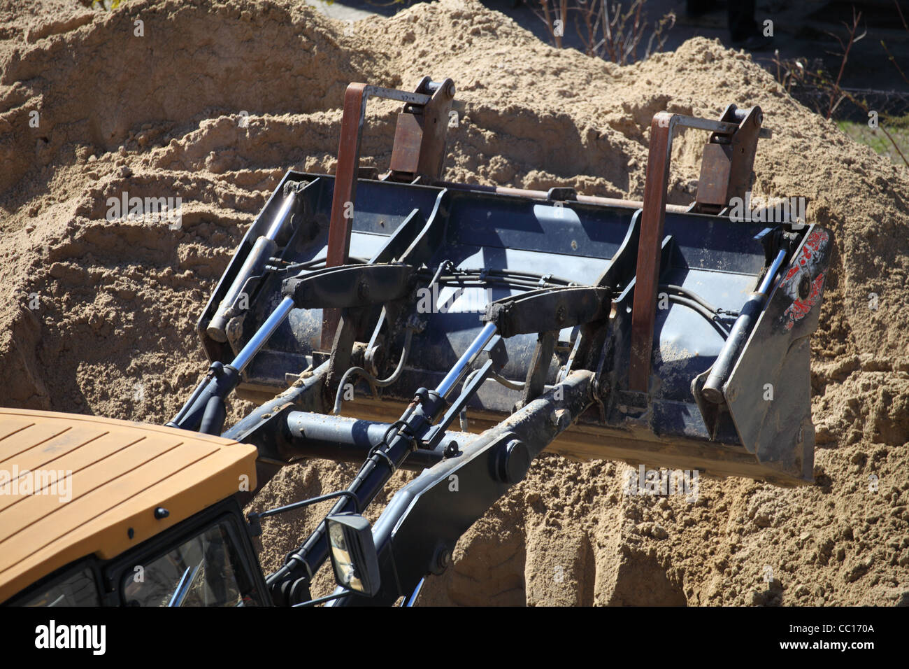 Yellow excavator on the construction site Stock Photo - Alamy