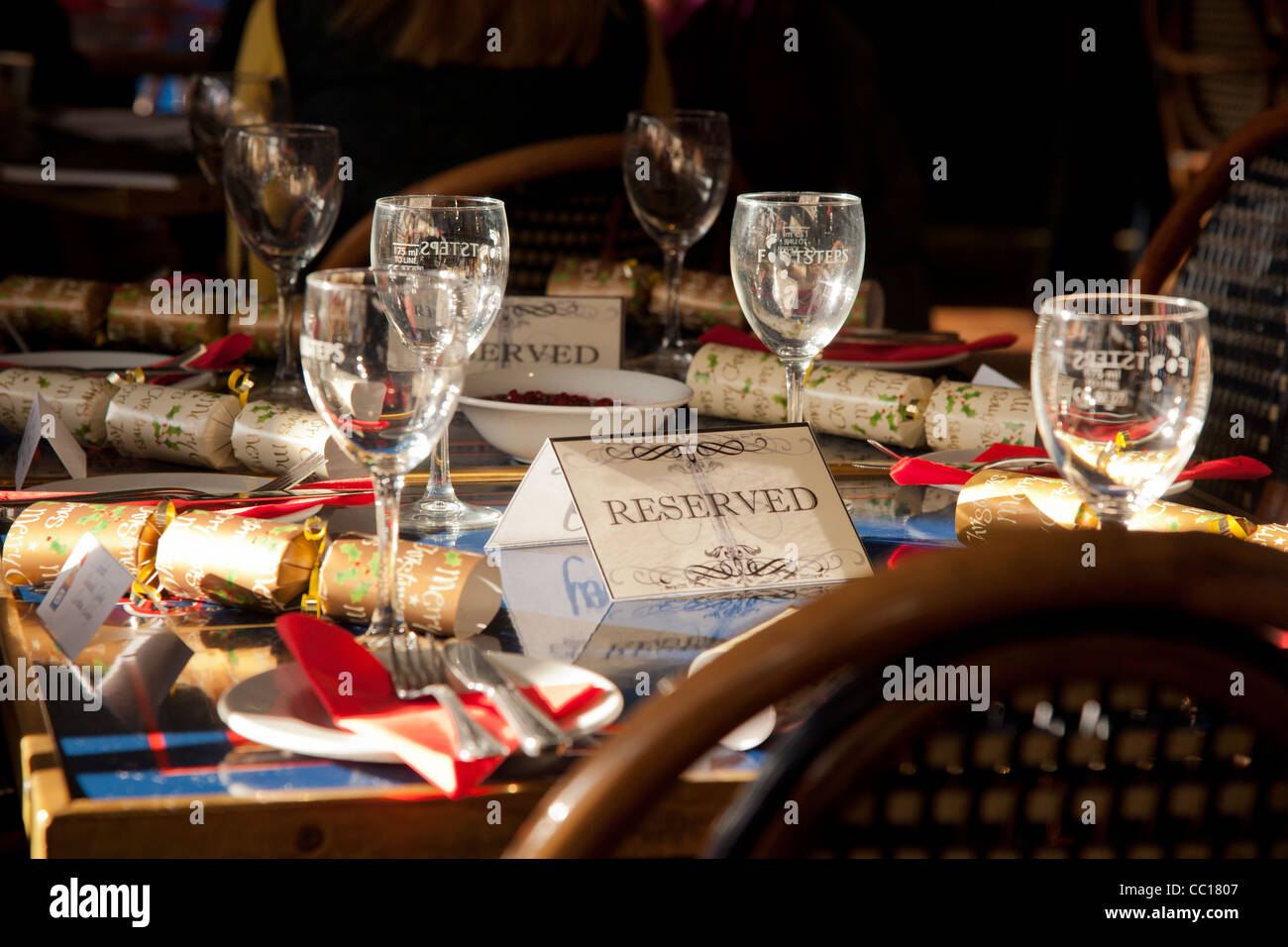 A restaurant table laid for a party with reserved label. Stock Photo
