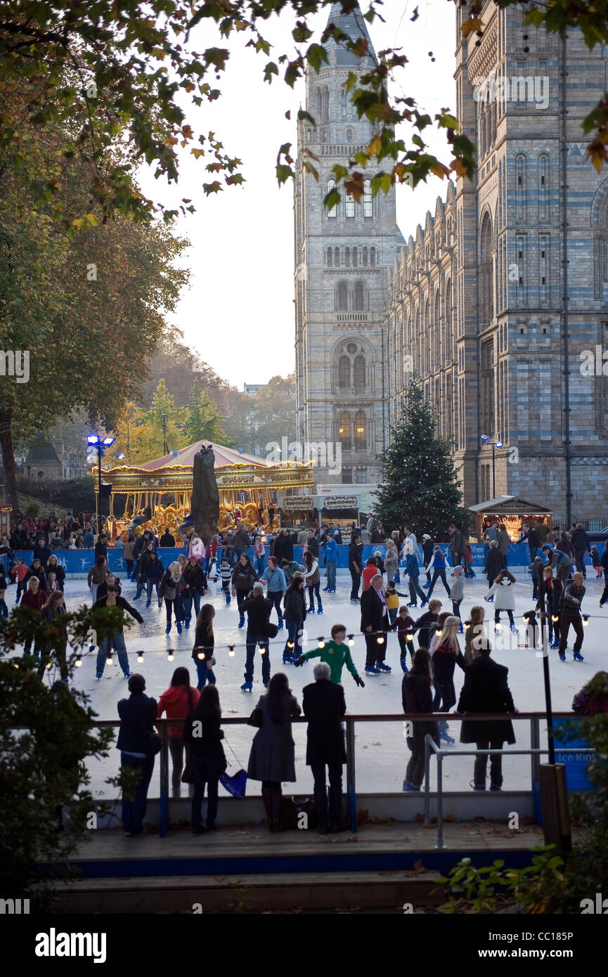 People skating on an ice rink outside the Natural History Museum, Kensington, London, UK Stock Photo