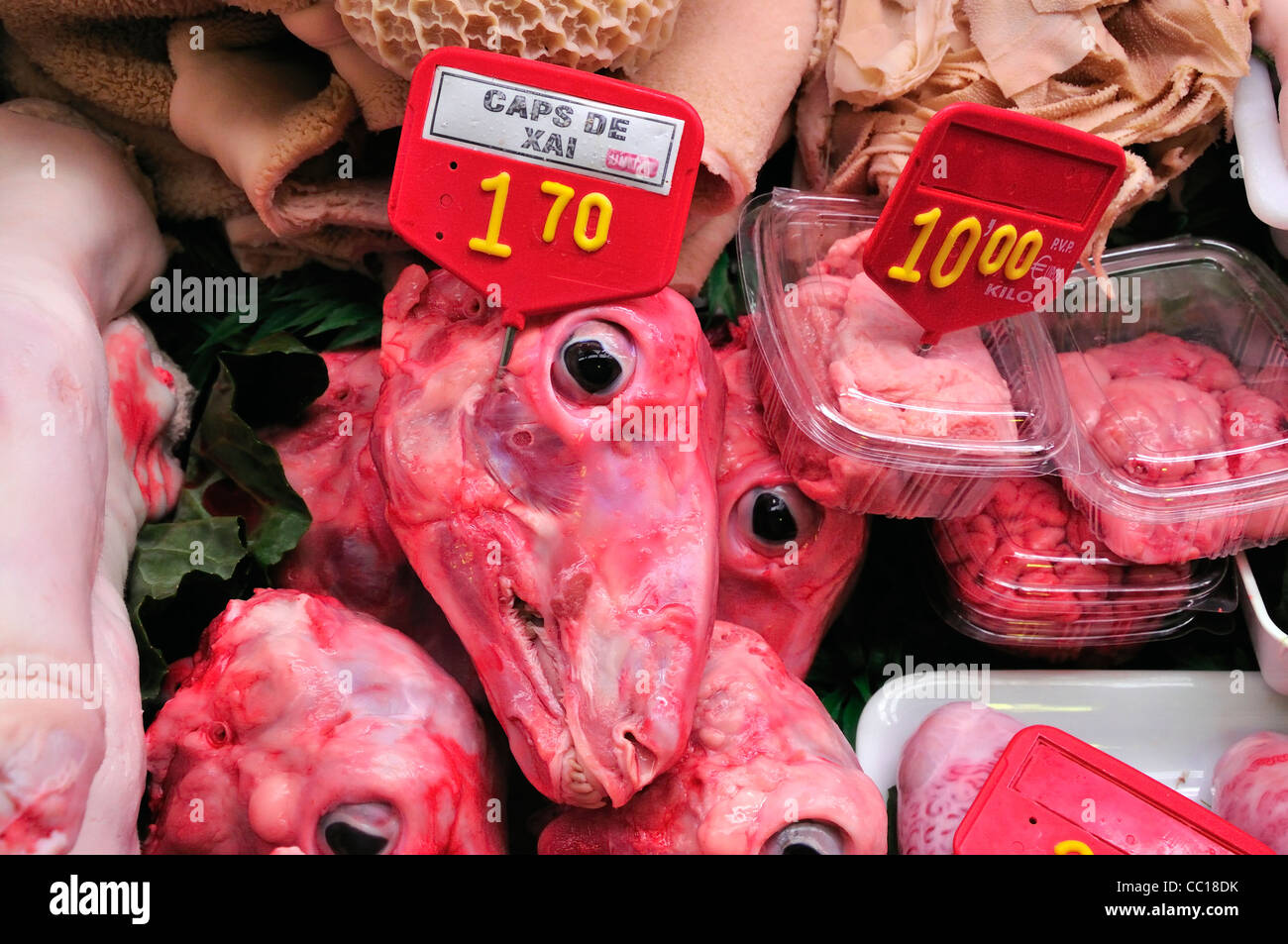 Barcelona, Spain. La Boqueria market. Sheeps' heads, tripe and offal on sale, with Catalan label Stock Photo