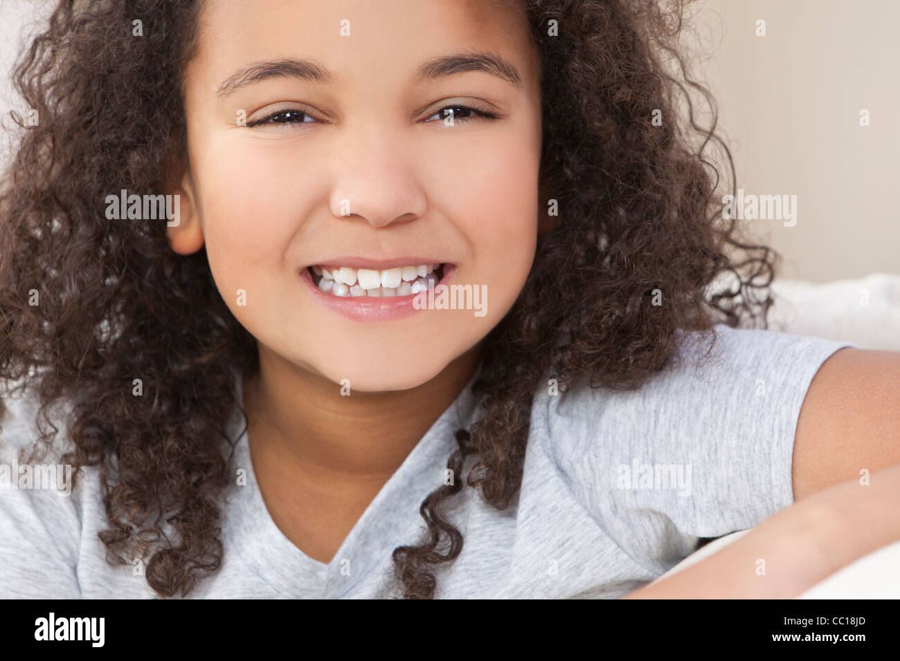 Studio shot of a beautiful young mixed race interracial African American  girl child smiling Stock Photo - Alamy