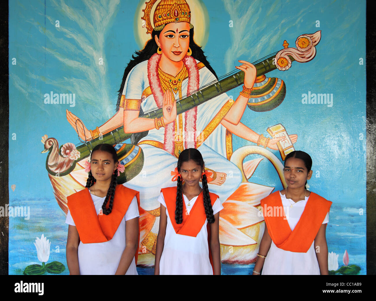 School student in front Saraswati Goddess of wisdom Andhra Pradesh South India Stock Photo