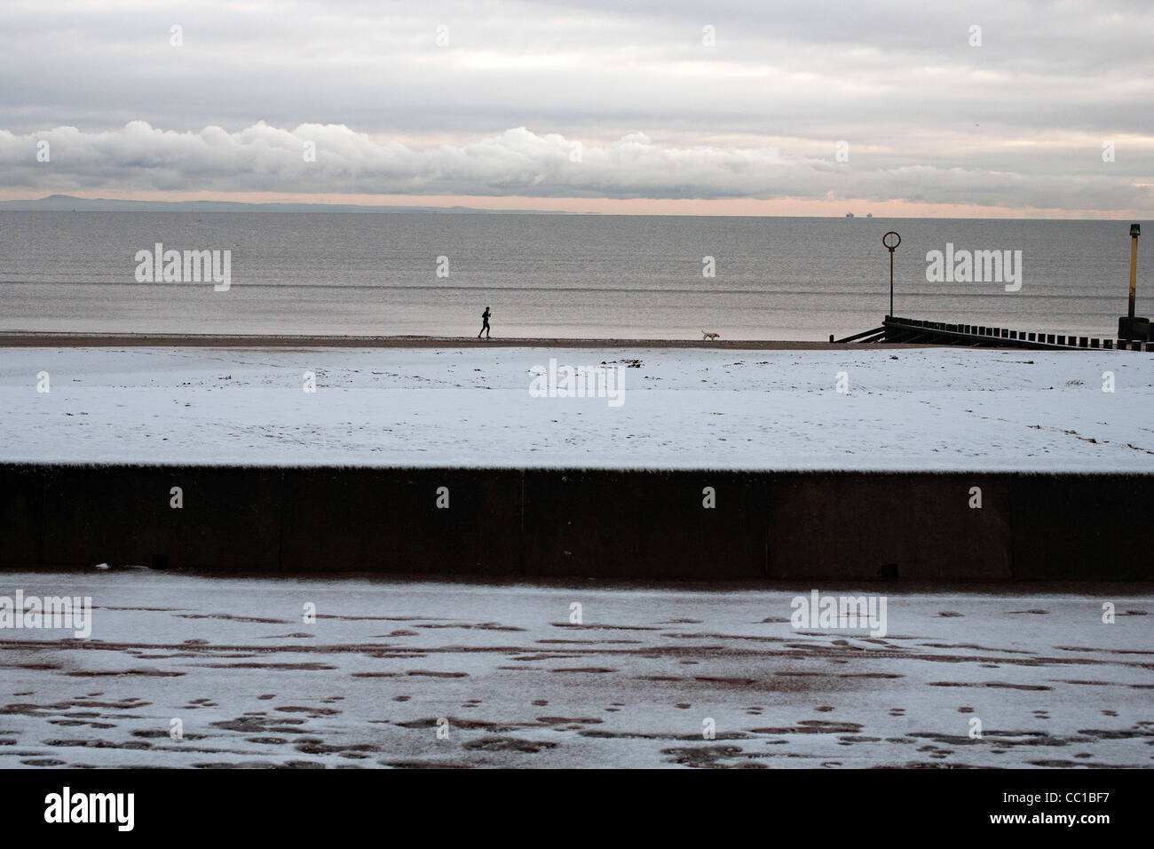 walker on portobello beach edinburgh Stock Photo Alamy