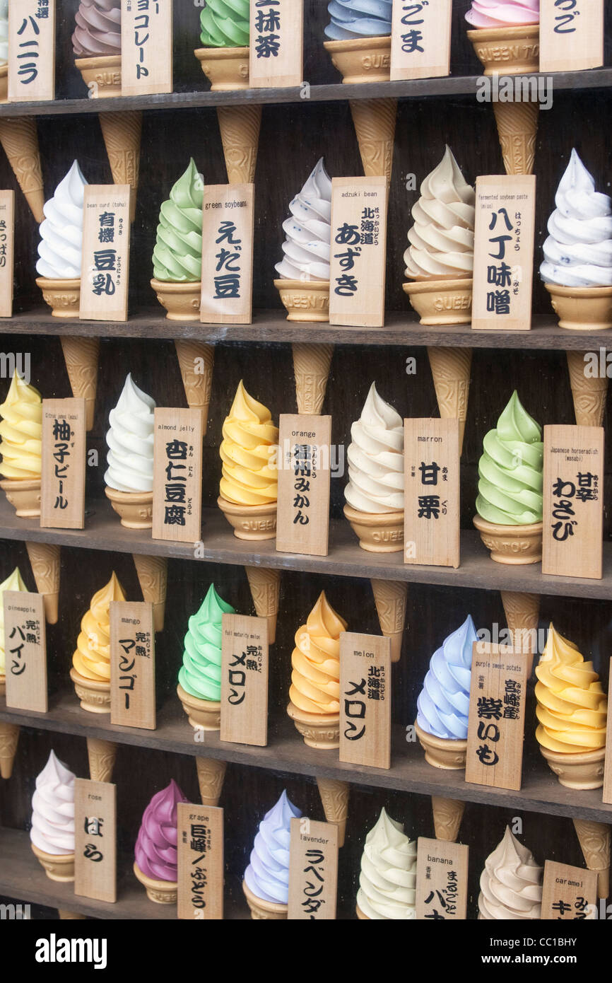 Plastic ice cream cones with different flavors on display in shop in