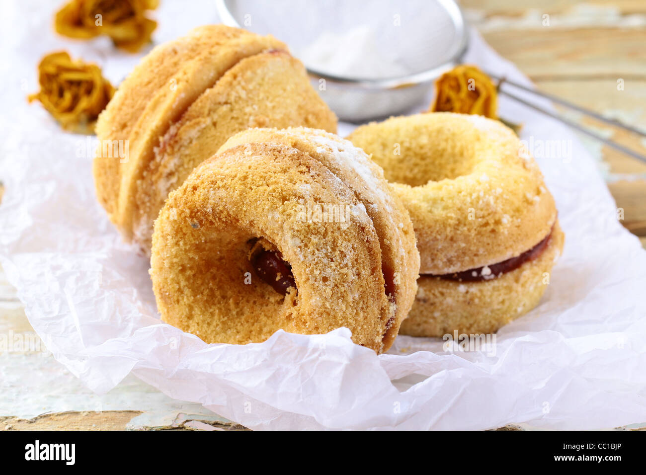 Freshly baked doughnuts sprinkled with icing sugar Stock Photo