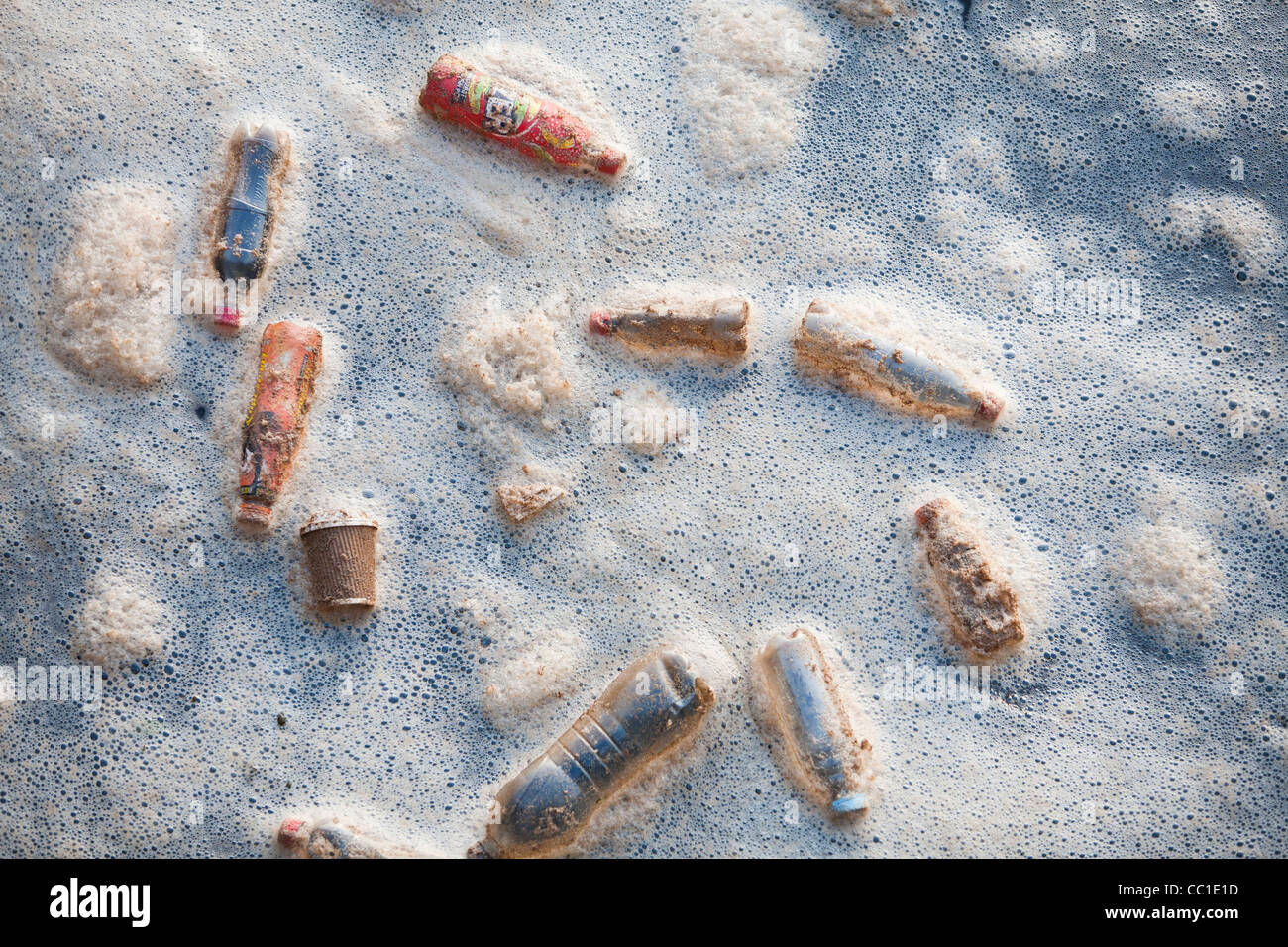 Plastic rubbish bottles floating in a dock in middlesbrough, Teeside, UK, in foam. Stock Photo