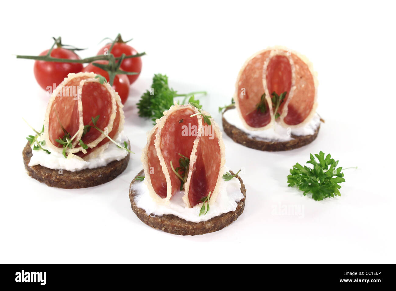 Pumpernickel bread with cream cheese, salami and garden cress Stock Photo Alamy
