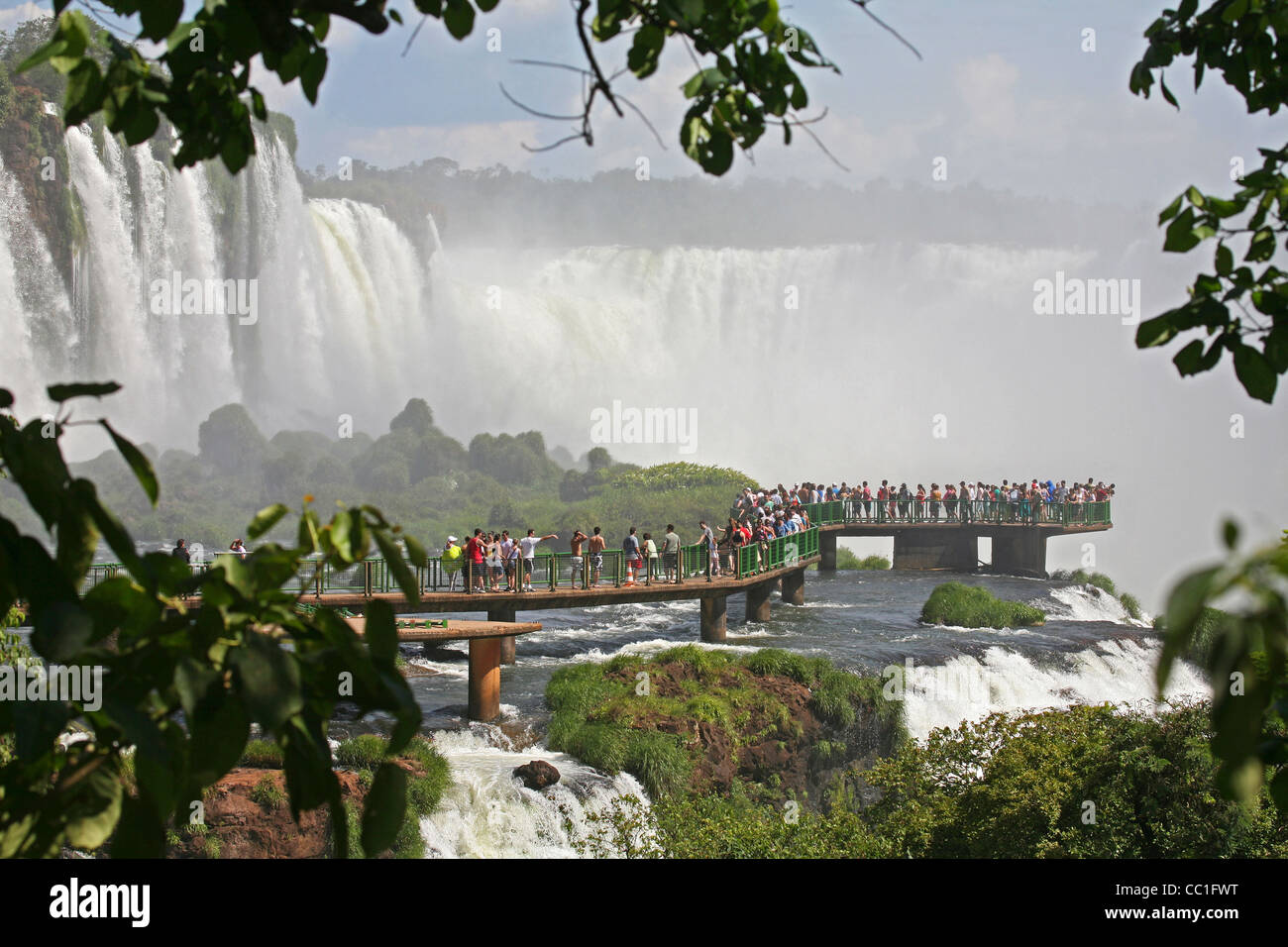 Tourists on walkway at the Iguazu Falls / Iguassu Falls / Iguaçu Falls on the border of Brazil and Argentina Stock Photo