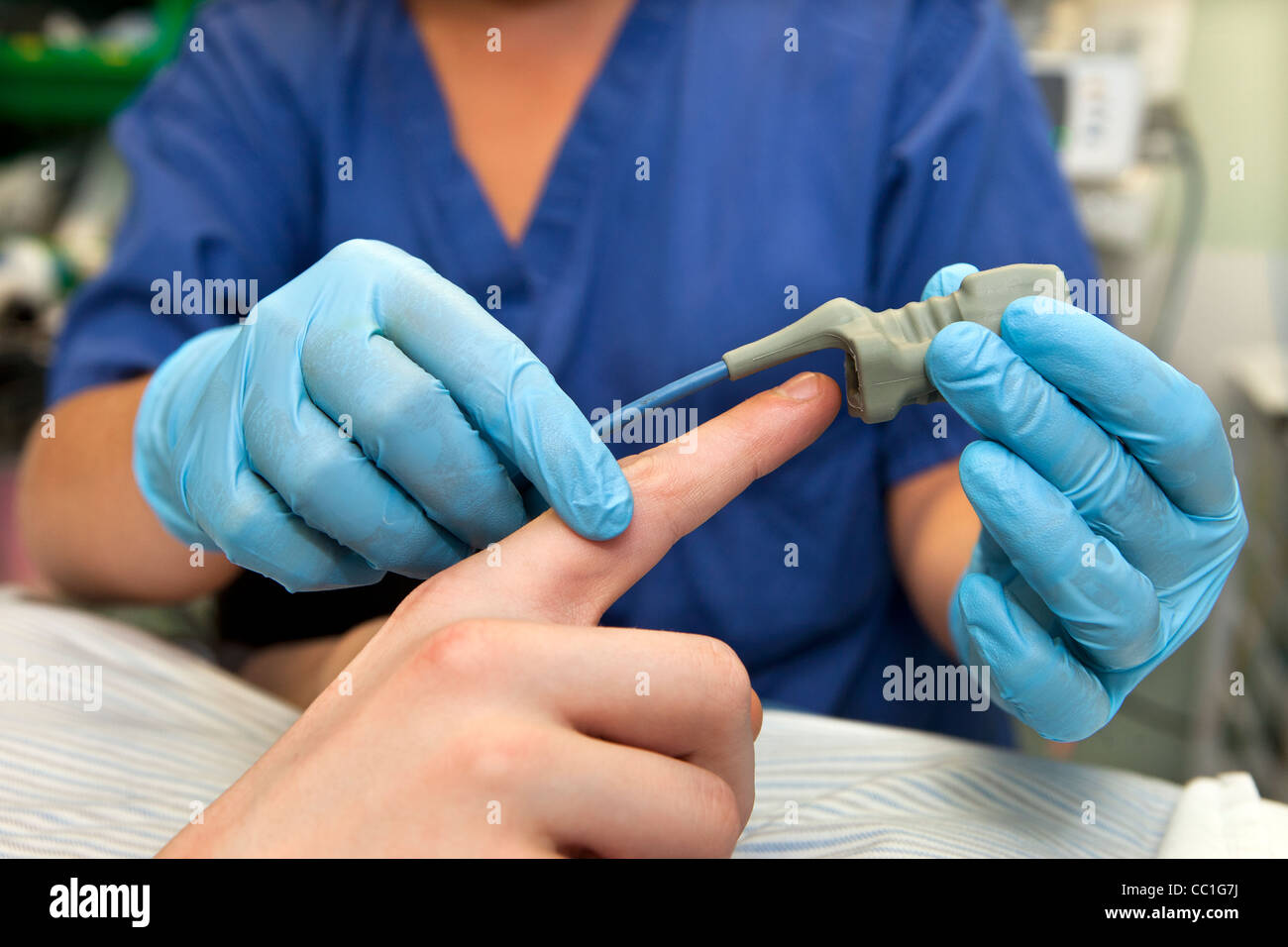 Arterial oxygenation being measured using pulse oximetry before surgical operation Stock Photo
