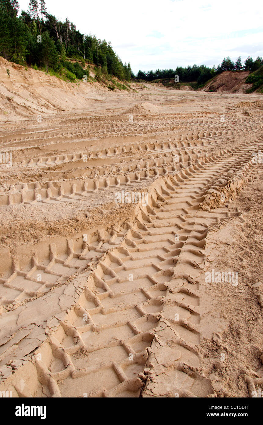 Freight car wheel marks left in the sand pit. Stock Photo