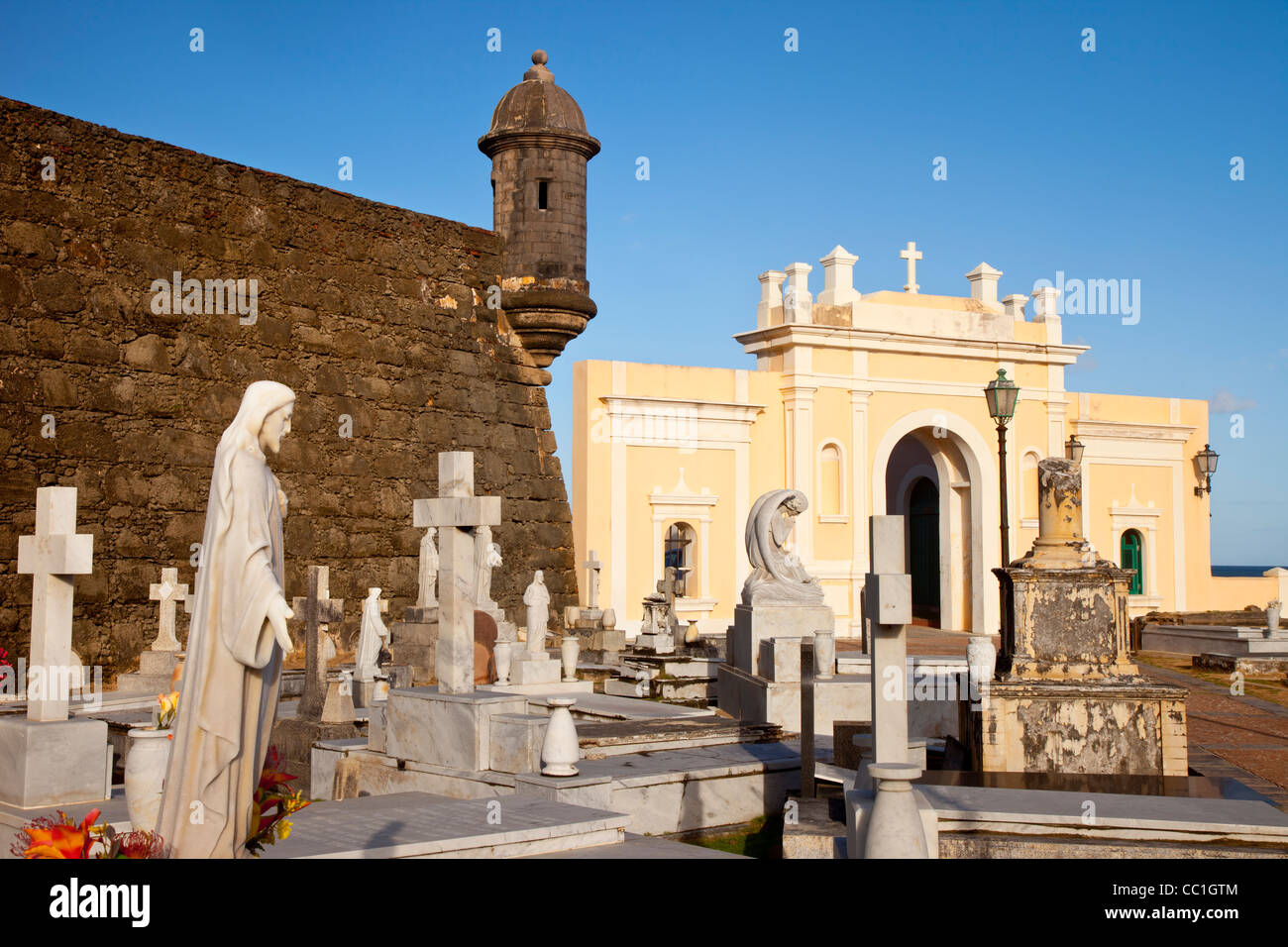 Sentry Turret from El Morro Fort stands guard over the Santa Maria Magdalena Cemetery in Old Town San Juan Puerto Rico Stock Photo