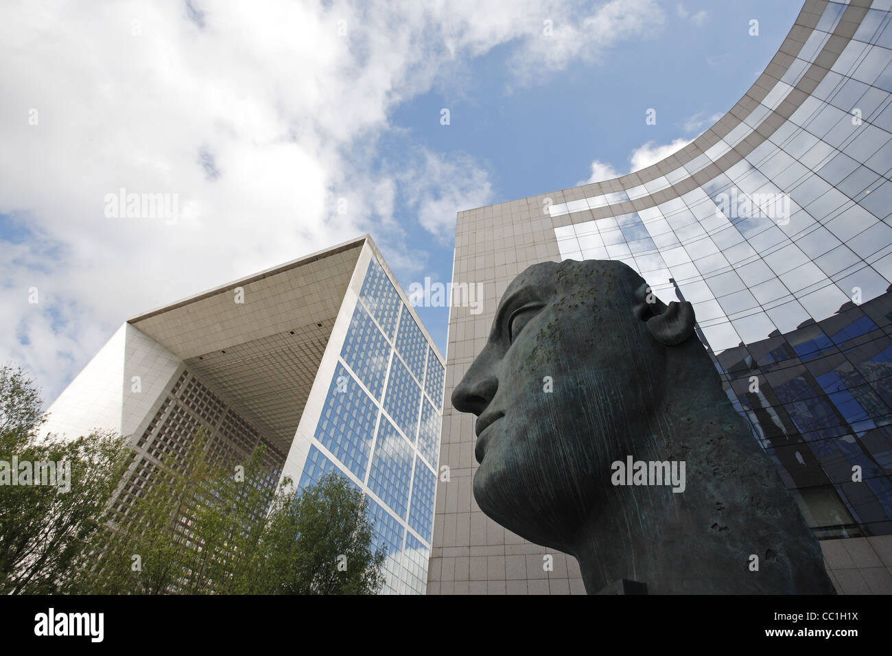 Igor Mitoraj's Tindaro statue and La Grande Arche de la Défense, Paris, France Stock Photo