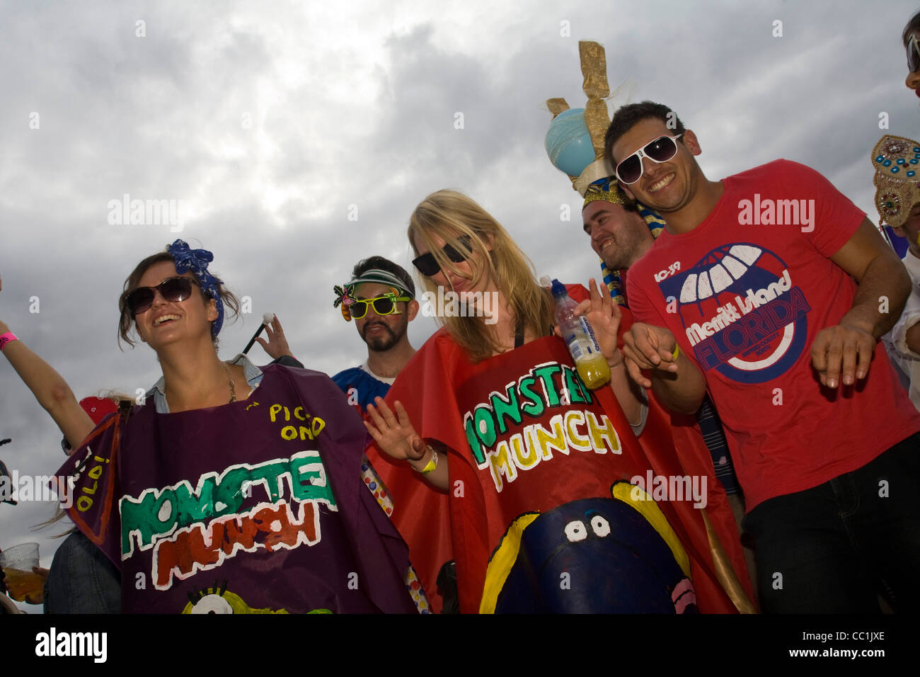 Men and women wearing Monster Much crisp packet costumes dance to music  at the Standon Festival Stock Photo