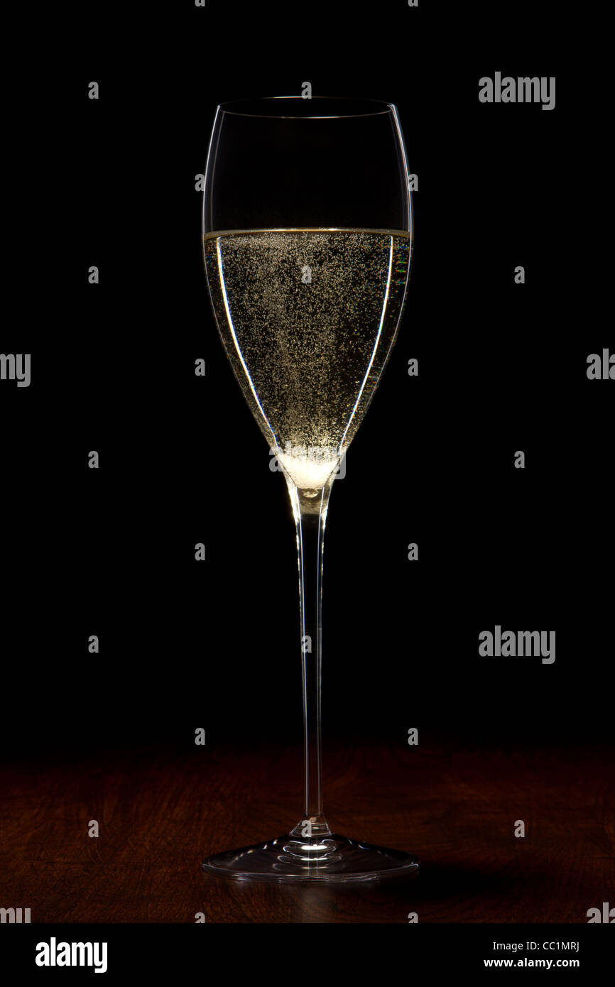 glass with champagne on a wooden table Stock Photo