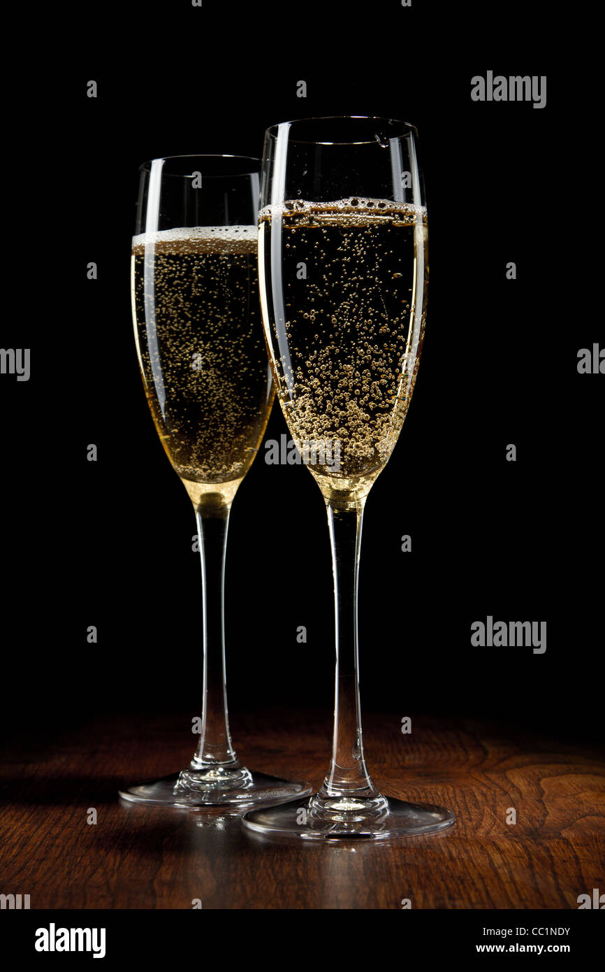 two glass with champagne on a wooden table Stock Photo