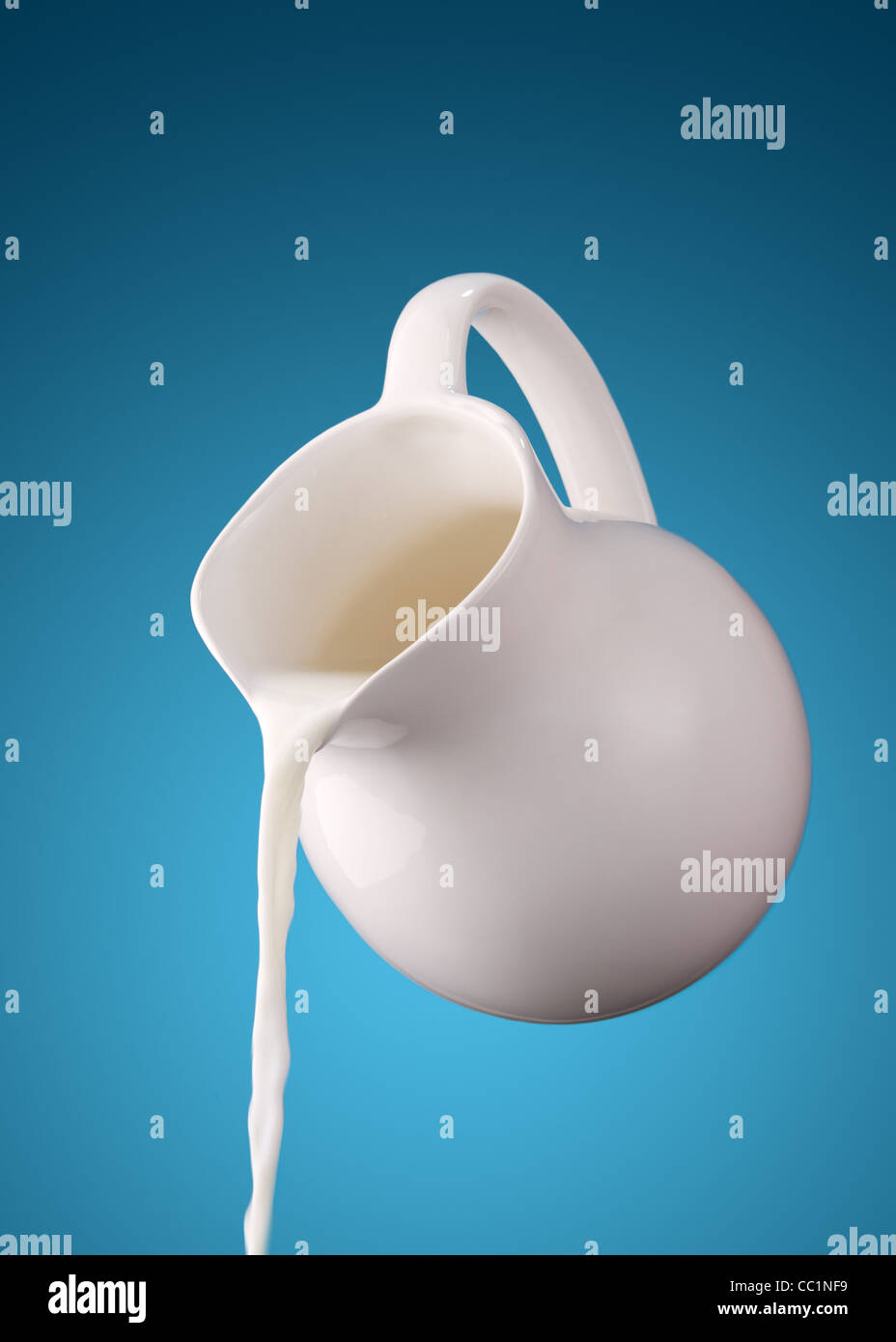 pitcher of milk on a blue background Stock Photo