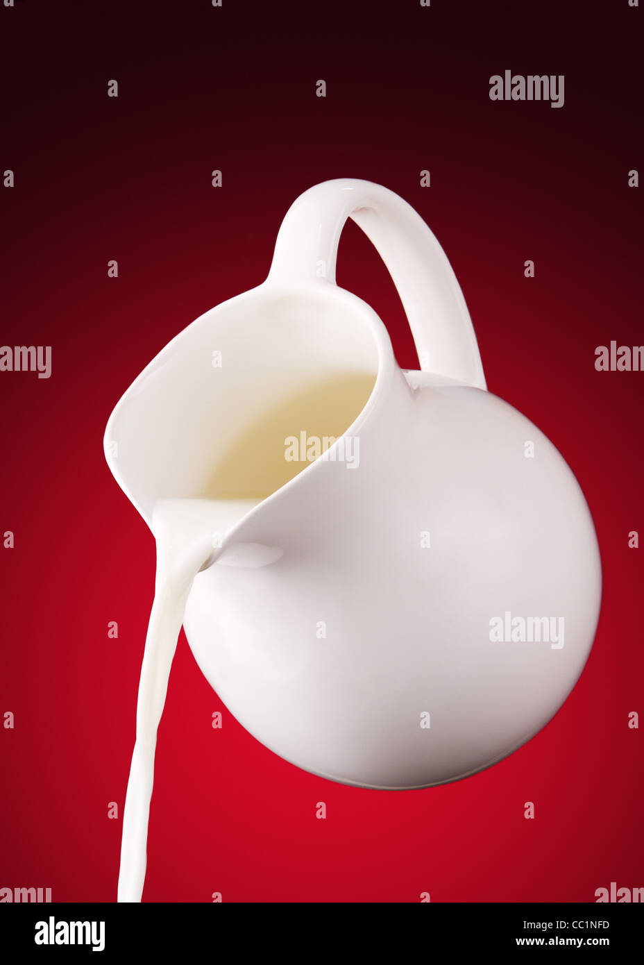 pitcher of milk on a red background Stock Photo
