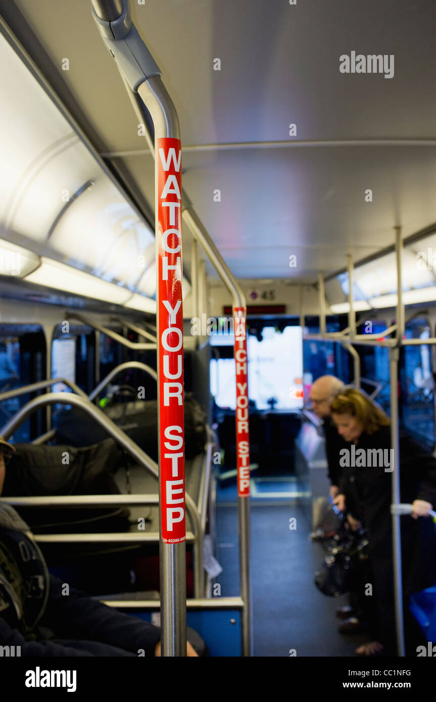 Watch Your Step - Warning at grab handle in a bus Stock Photo