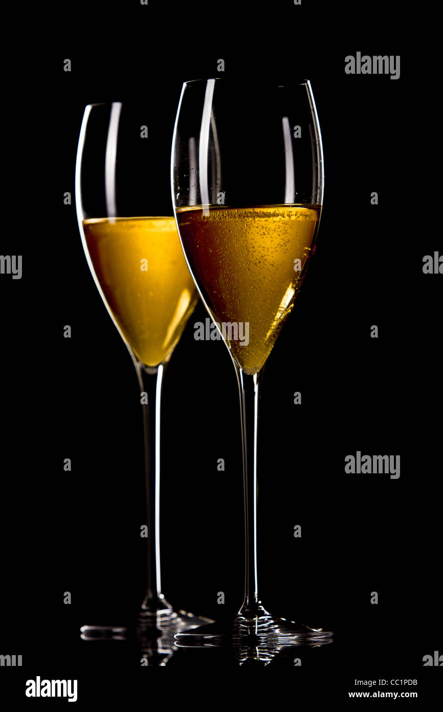 A glass of champagne, isolated on a yellow background. Stock Photo
