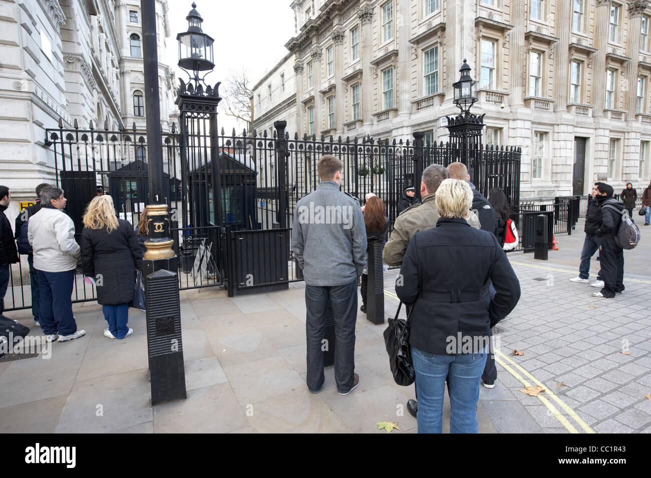 tourists outside the closed security gates of downing street at whitehall London England UK United kingdom Stock Photo