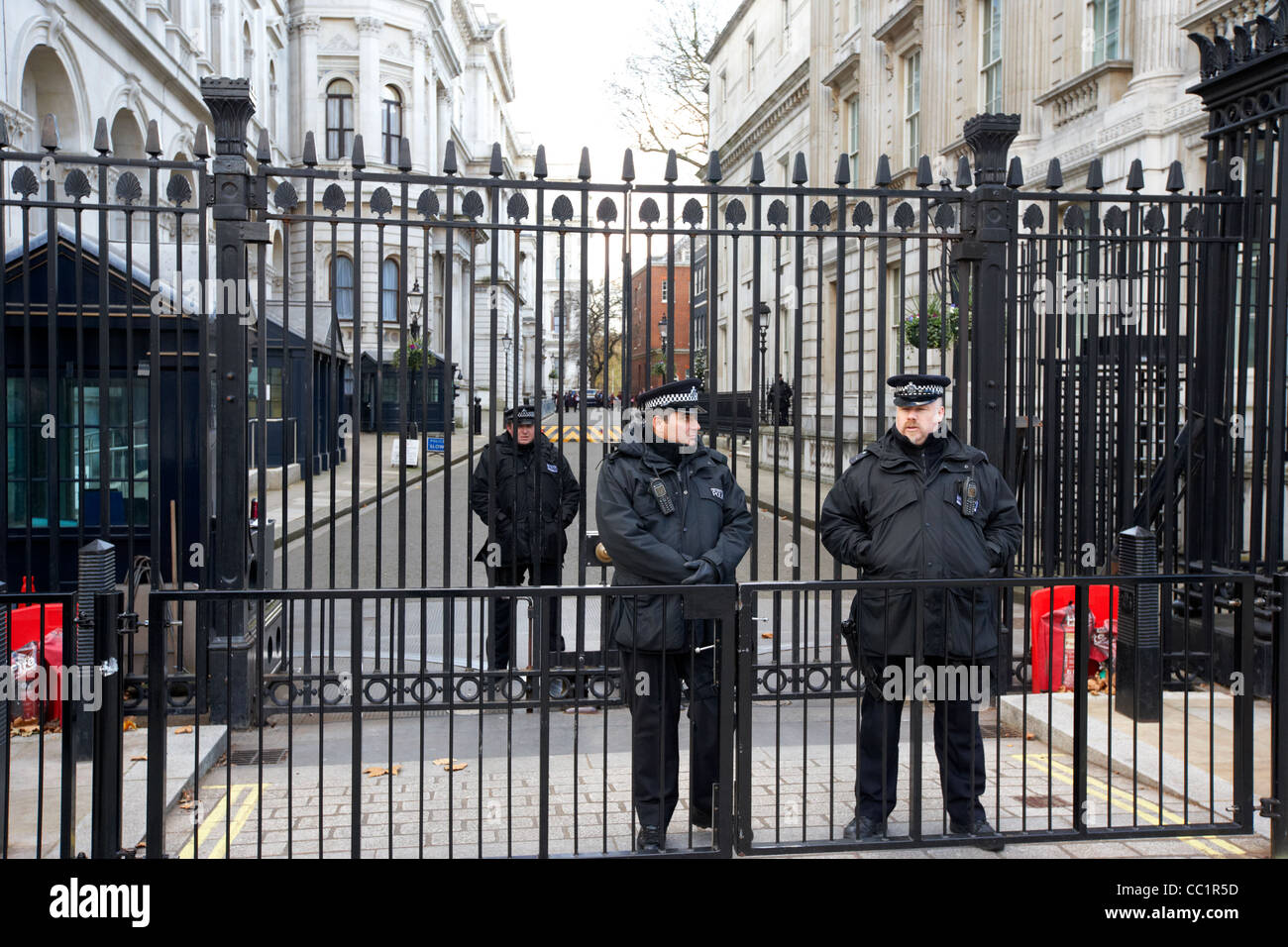 metropolitan police armed protection officers outside the security gates of downing street at whitehall London England UK Stock Photo