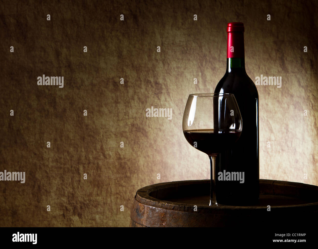 the still life with red wine, bottle, glass and old barrel Stock Photo