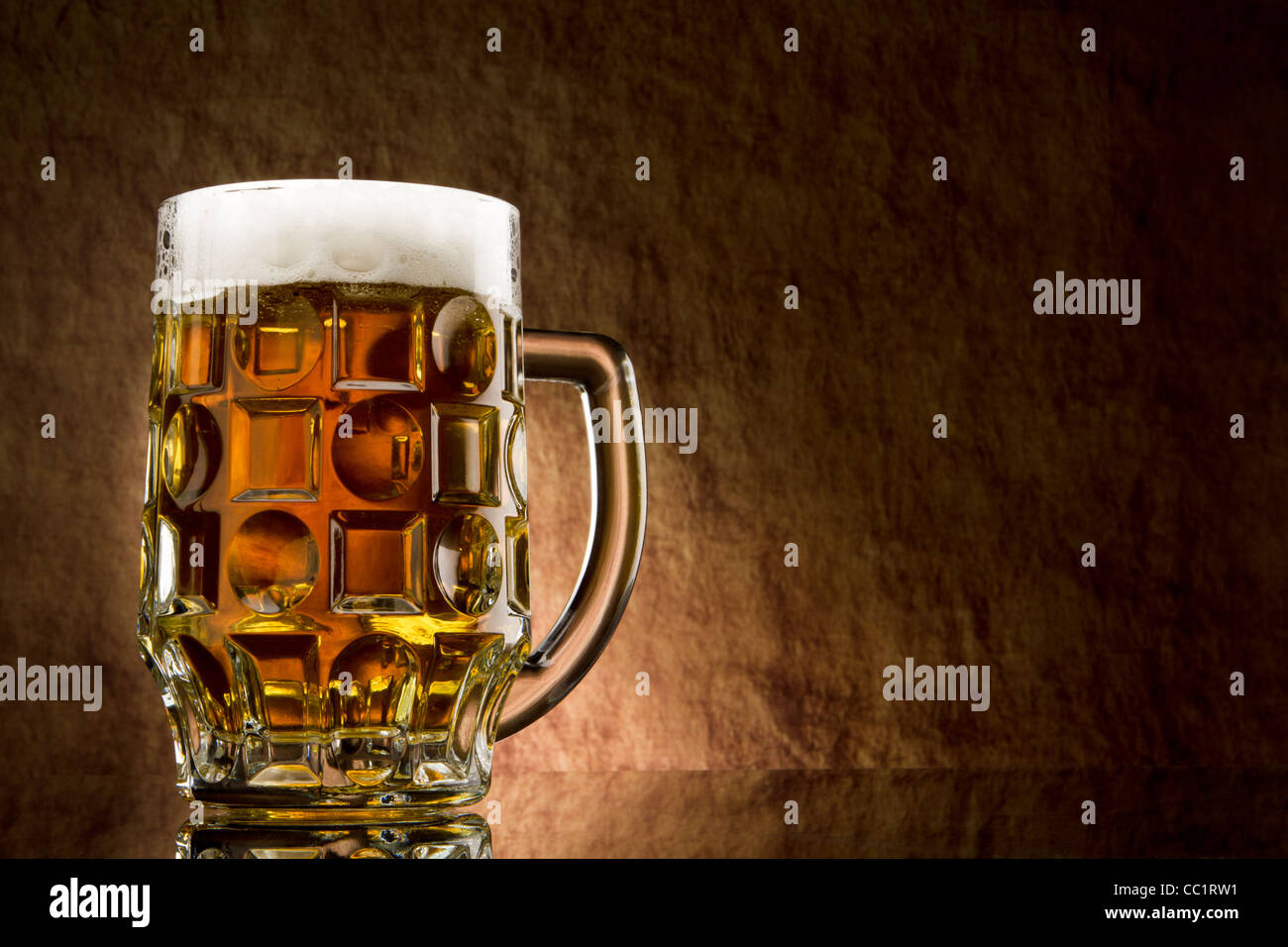 Beer into glass on a old stone Stock Photo