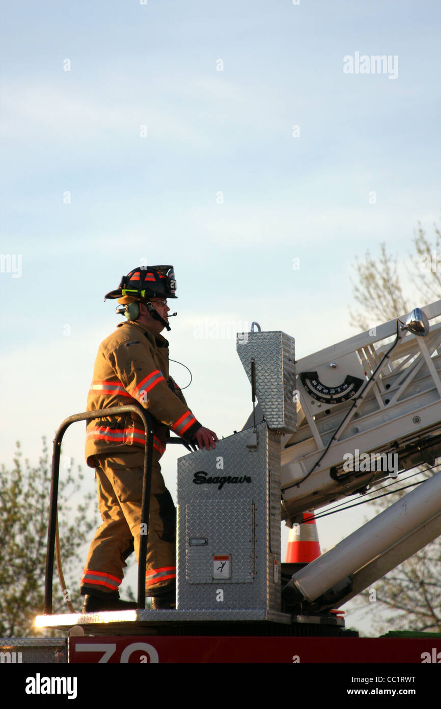 A firefighter at the controls of a ladder truck Stock Photo - Alamy