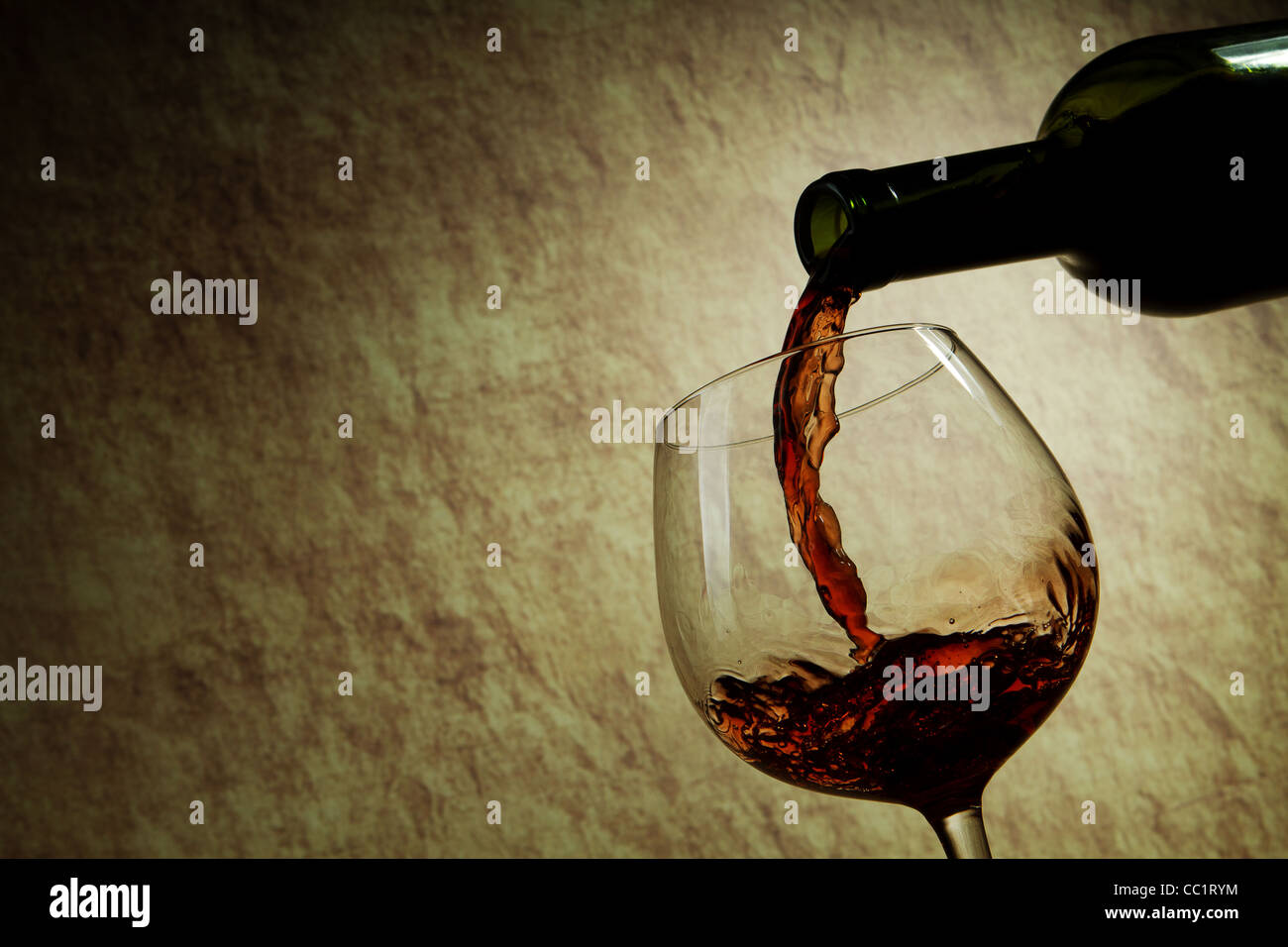 Red Wine glass and Bottle on a old stone Stock Photo
