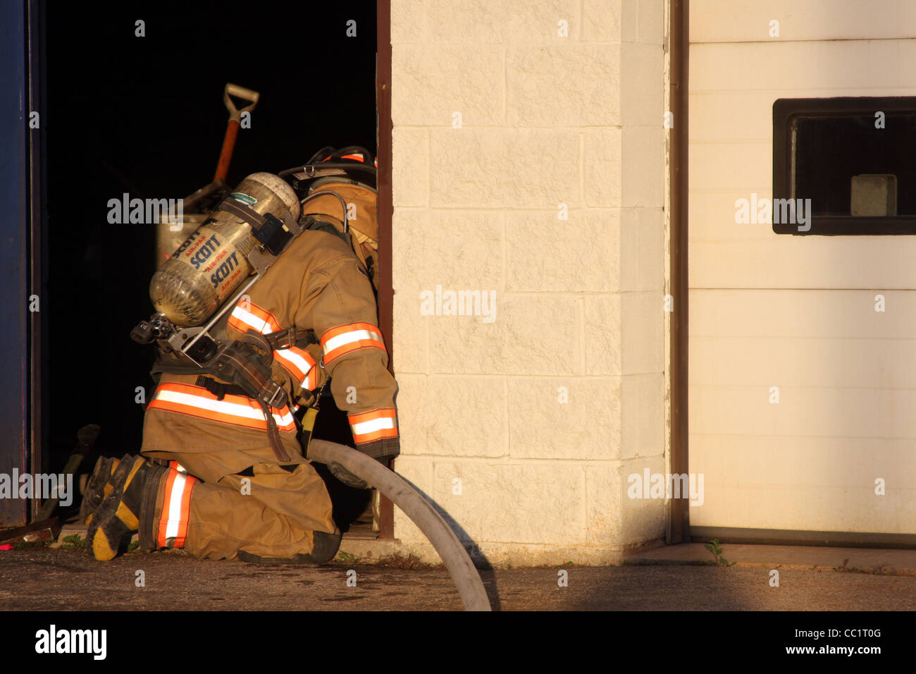 Firefighters entering a building for search and rescue Stock Photo