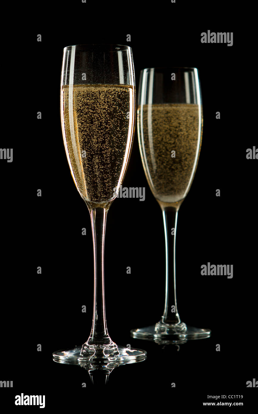 A glass of champagne, isolated on a black background. Stock Photo