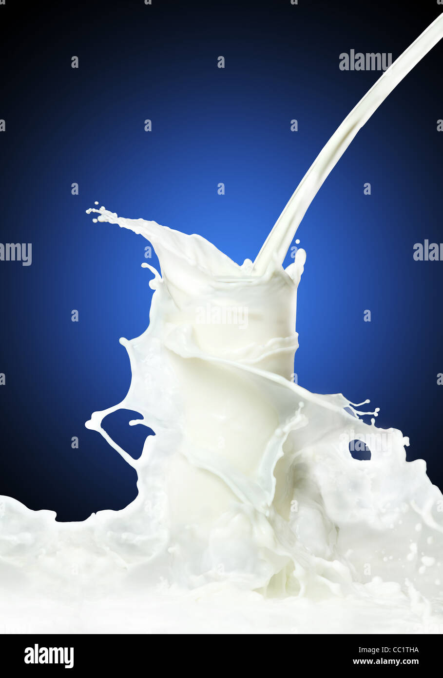 Milk splash on a blue gradient background Stock Photo