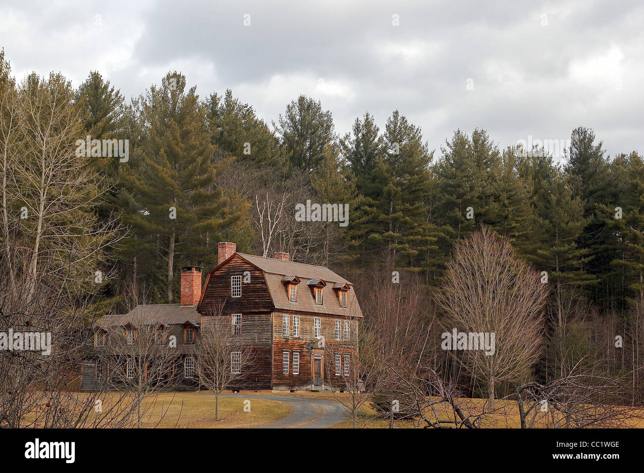 A winter view of a home amidst trees in the town of Rowe, Massachusetts, United States Stock Photo