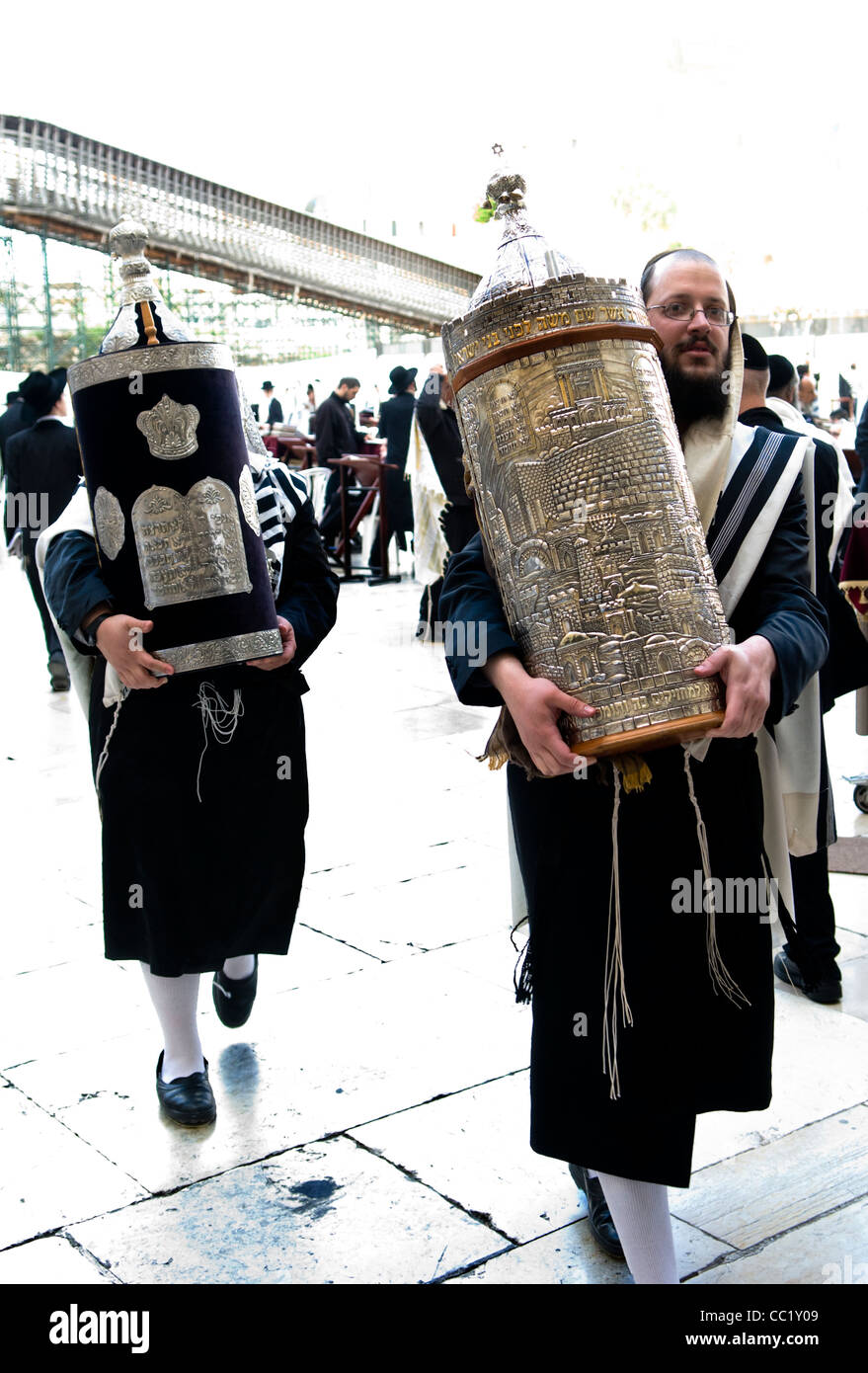 Orthodox Jewish men holding the Torah scroll books at the Wailing wall in Jerusalem. Stock Photo