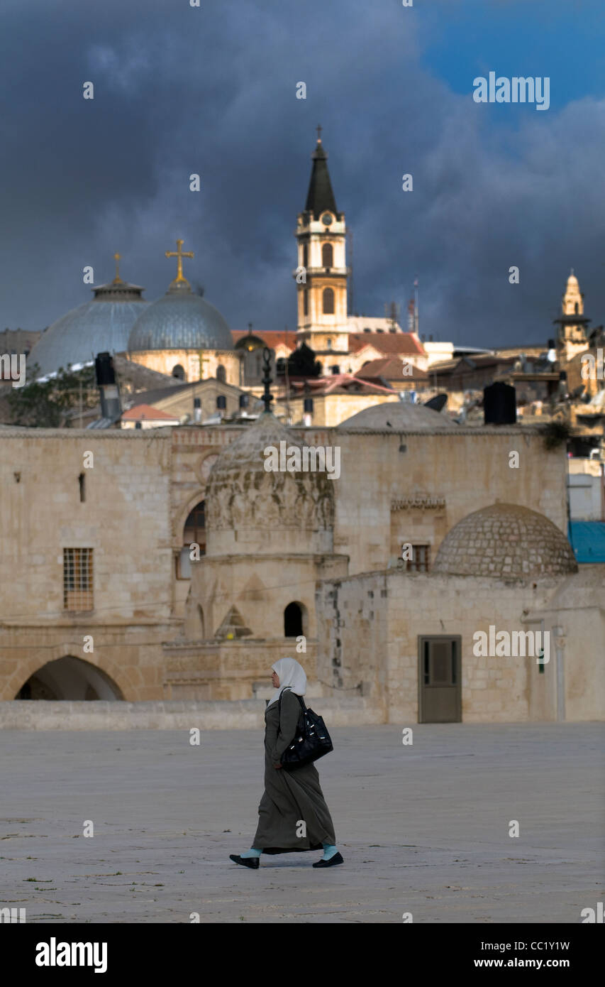 An Arab woman wearing a Hijab walking on the grounds of the Temple Mount in the old city of Jerusalem. Stock Photo