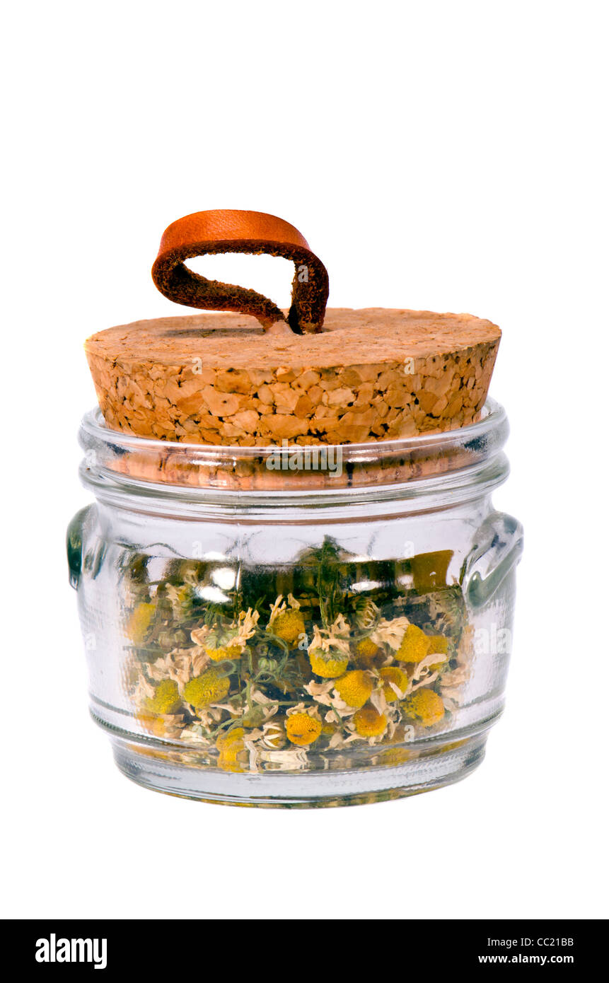isolated chamomile tea in the little glass pot Stock Photo