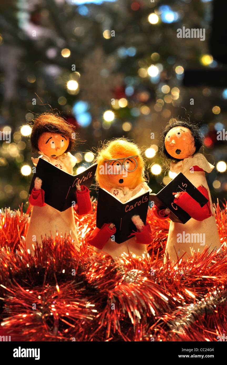 Three model choir boys singing - a Christmas decoration in portrait format UK Stock Photo