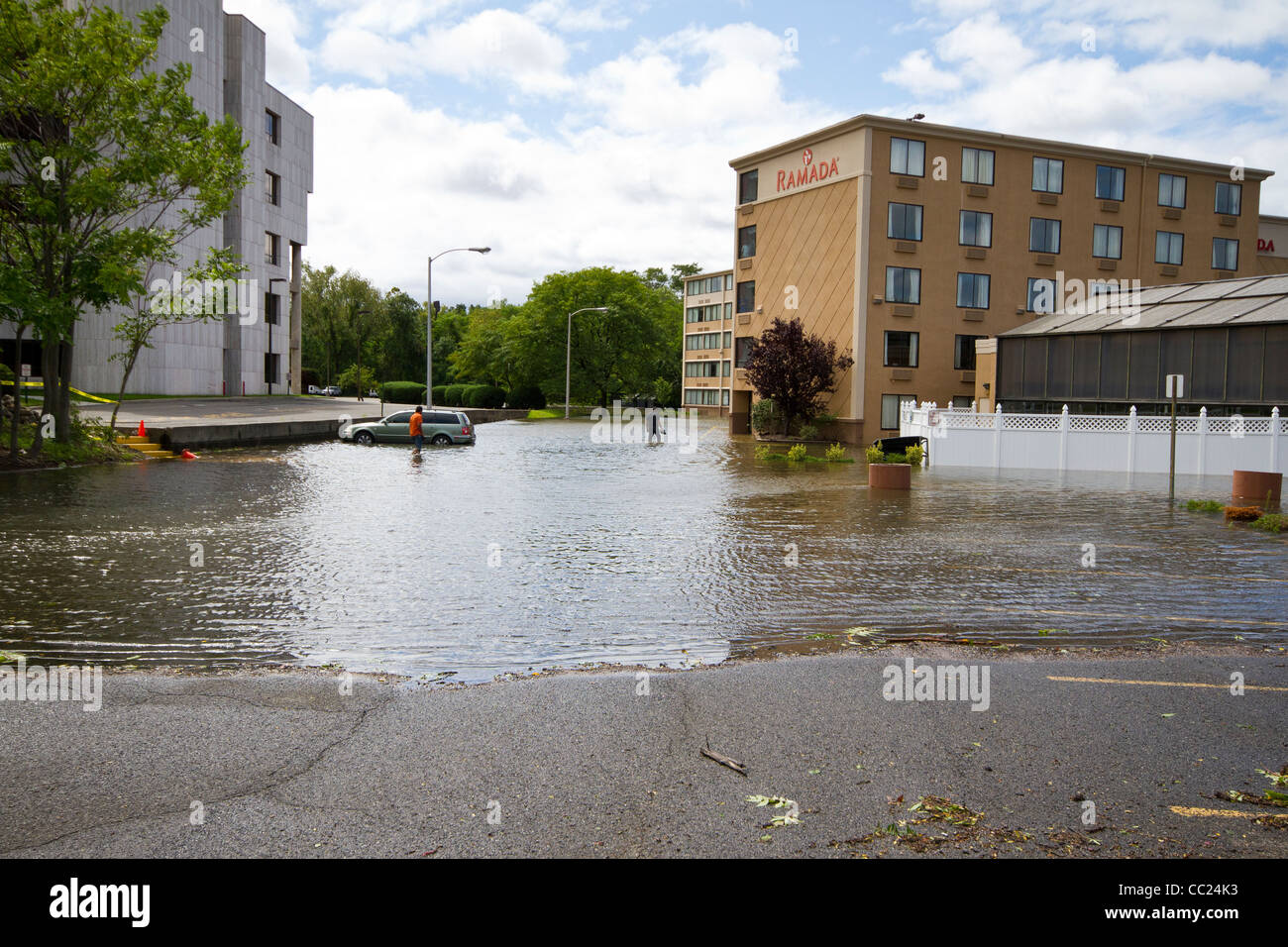 People crossing a flooded parking lot at the Ramada Hotel - Hurricane Irene  aftermath, New Jersey Stock Photo - Alamy