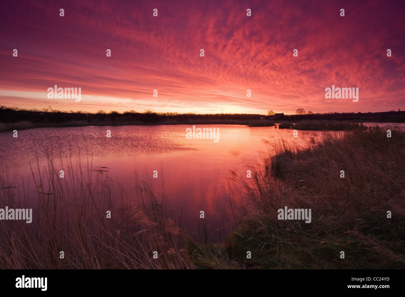 A colourful sunrise at the Far Ings National Nature Reserve in North Lincolsnhire on a cold January morning Stock Photo