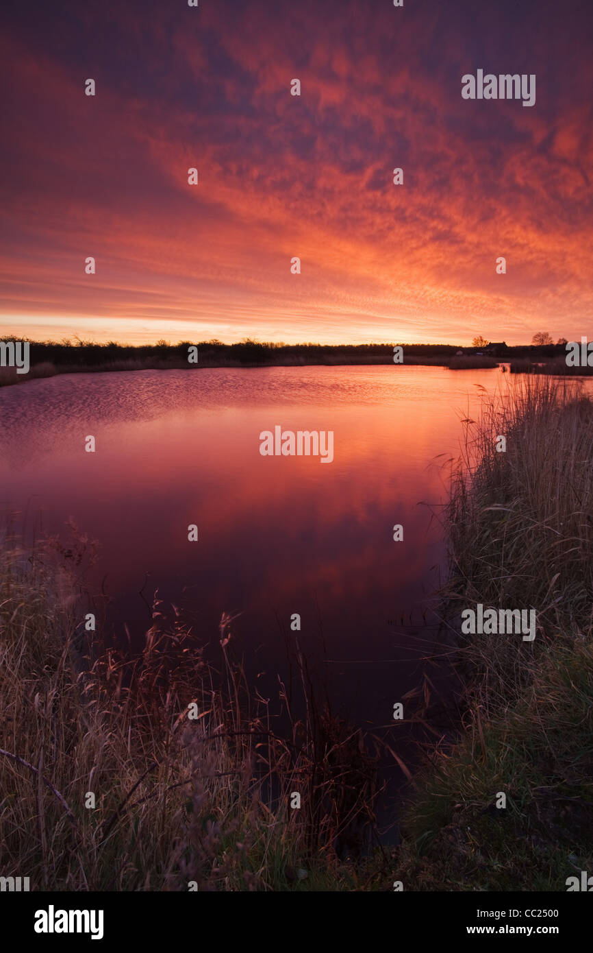 A colourful sunrise at the Far Ings National Nature Reserve in North Lincolsnhire on a cold January morning Stock Photo