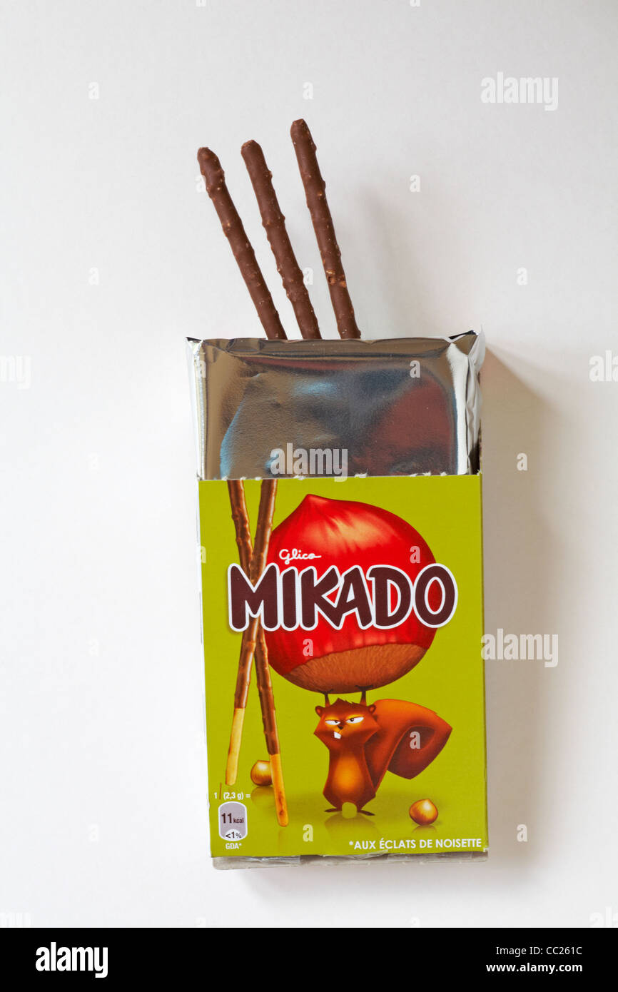 Packet of Glico Mikado totally hazelnut chocolate covered biscuits with packet opened to show contents isolated on white background - Mikado sticks Stock Photo
