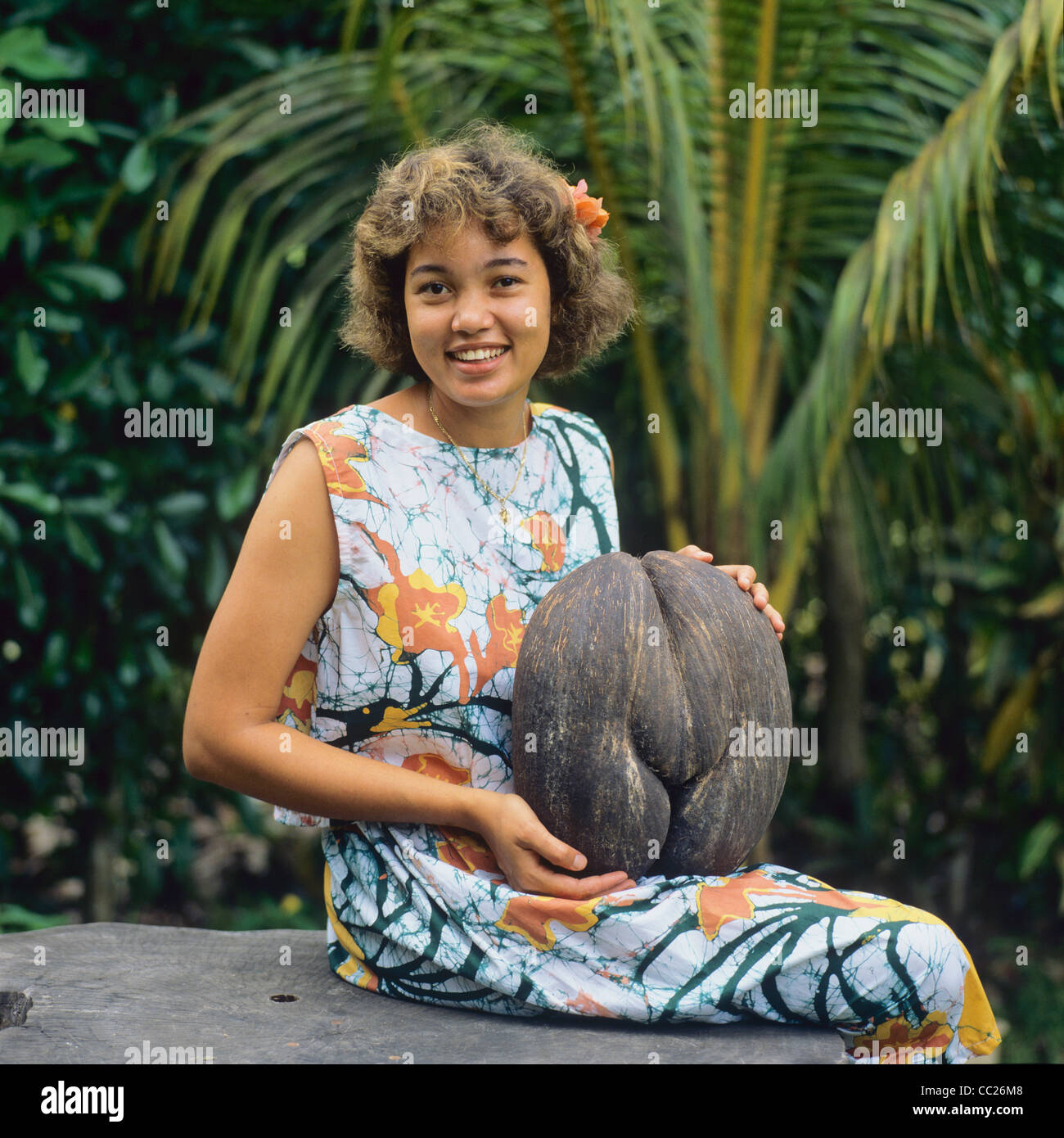 MR, Young Creole woman with a Coco de Mer nut, Praslin island ...
