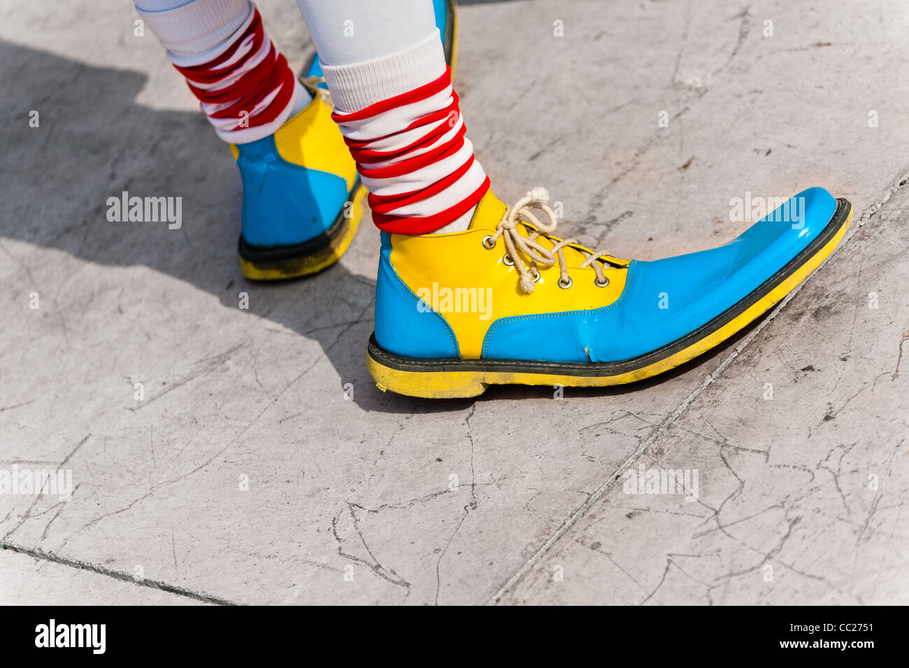 A clown wears oversized multi colored shoes during the Clown Congress ...