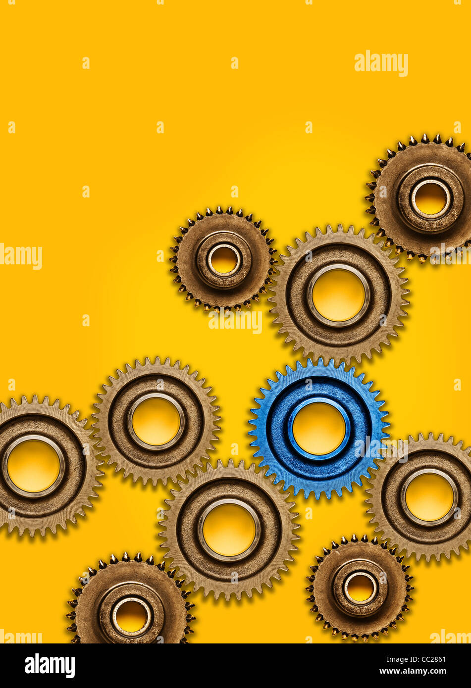 A selection of cogs on a yellow background Stock Photo