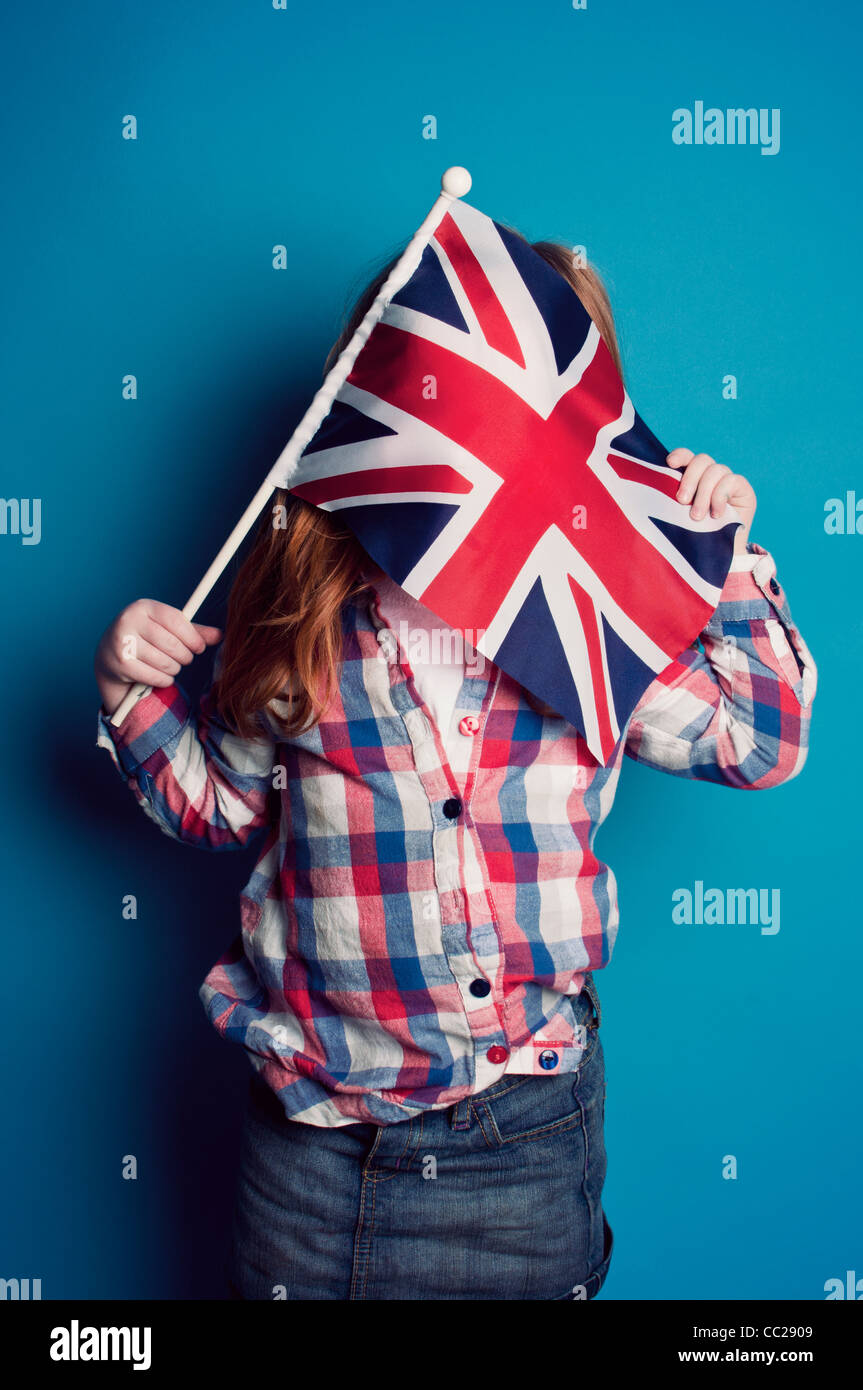 A young girl holding a British flag Stock Photo